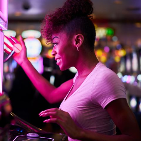 happy-woman-gambling-at-casino-playing-slot-machine-1.jpg